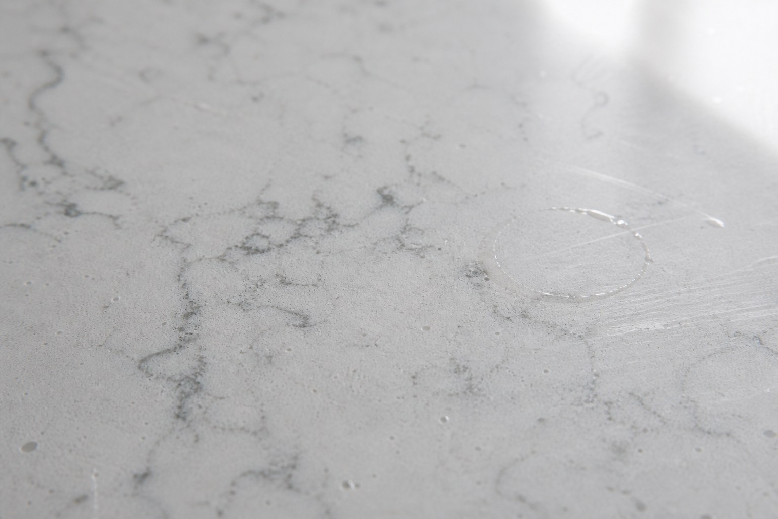 Quartz countertop and waterfall edge in a newer Milpitas kitchen protected with padding beside an integrated Sub-Zero cabinet run